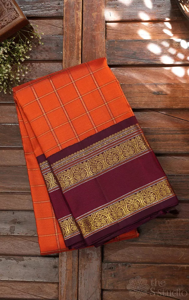 Orange kanjivaram silk saree with zari checks and korvai brown border