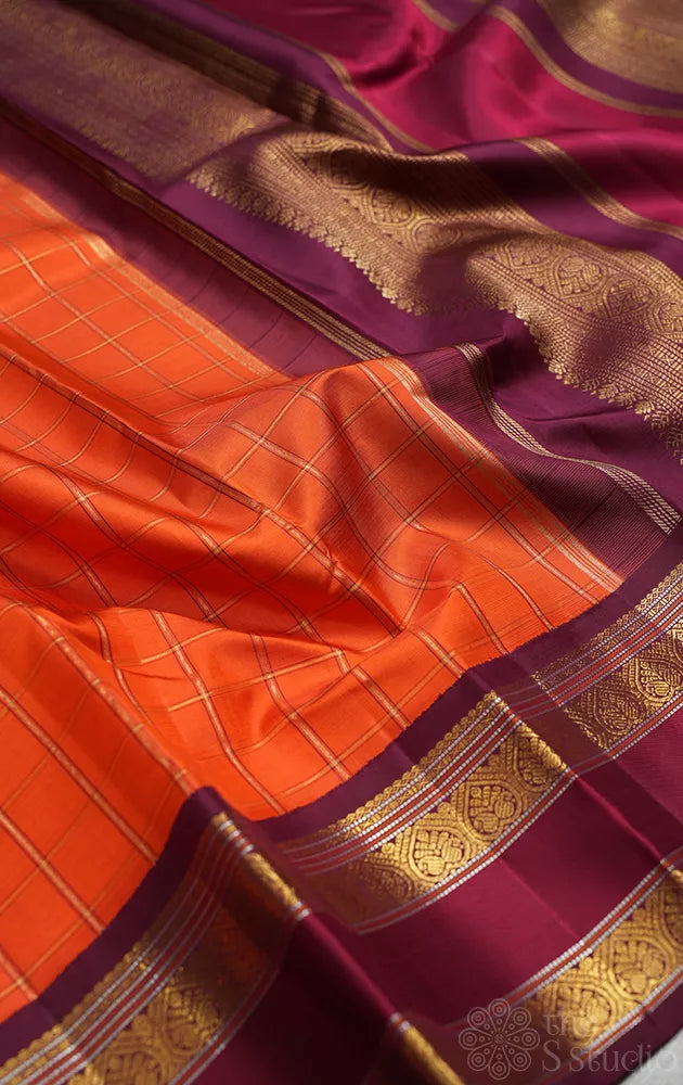 Orange kanjivaram silk saree with zari checks and korvai brown border