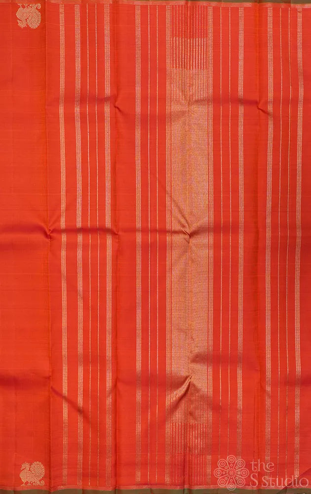 Rust orange kanchi silk saree with peacock motifs along the border