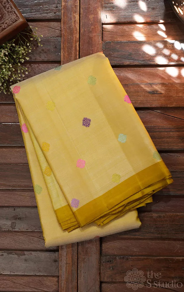 Golden beige kanjivaram silk saree with thread buttas and a zari pallu