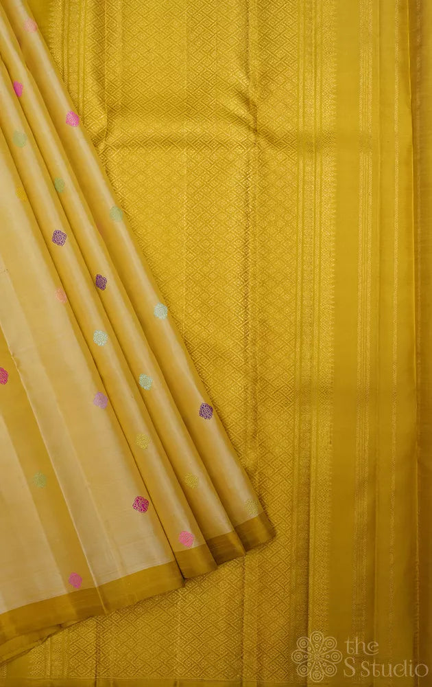 Golden beige kanjivaram silk saree with thread buttas and a zari pallu