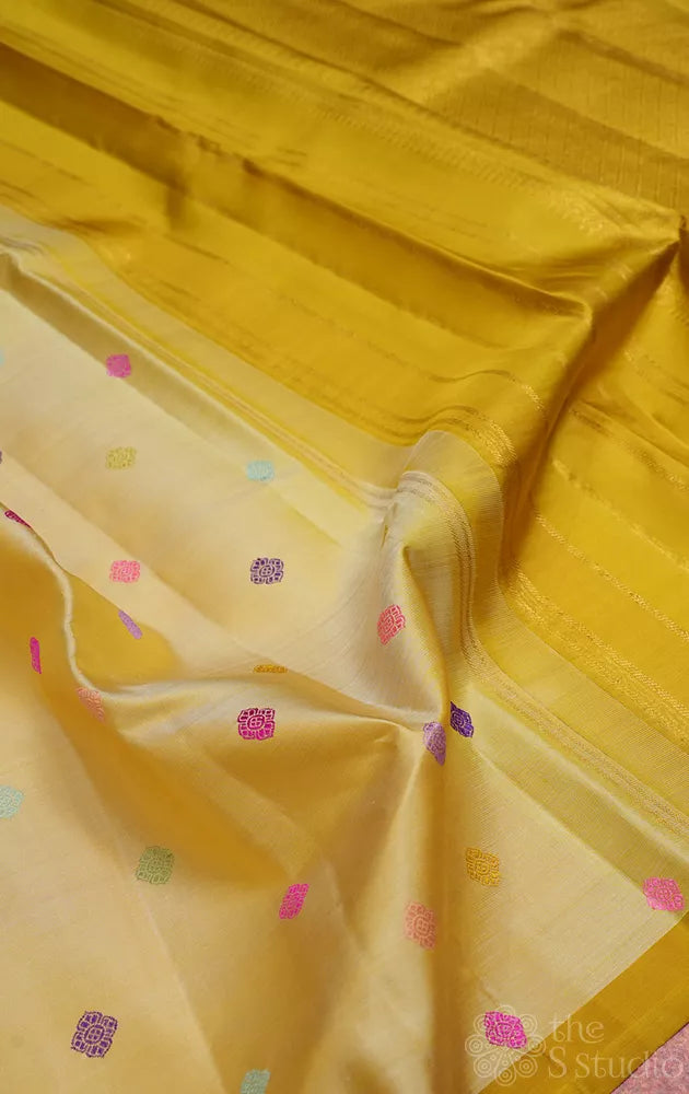 Golden beige kanjivaram silk saree with thread buttas and a zari pallu