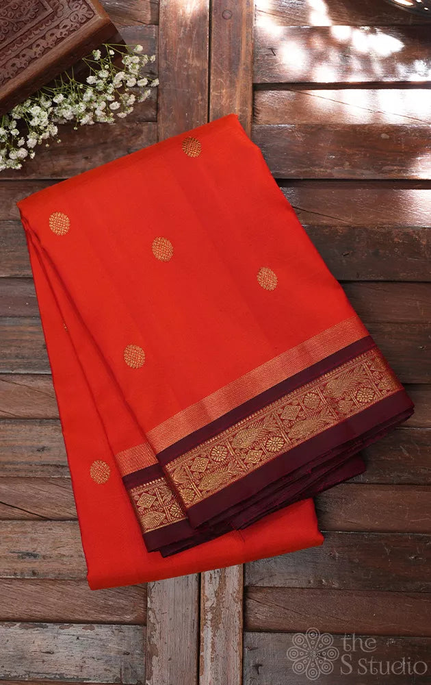 Bright orange kanjivaram silk saree with brown border