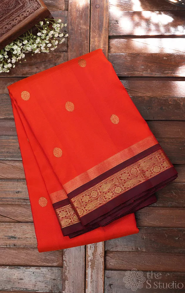 Bright orange kanjivaram silk saree with brown border