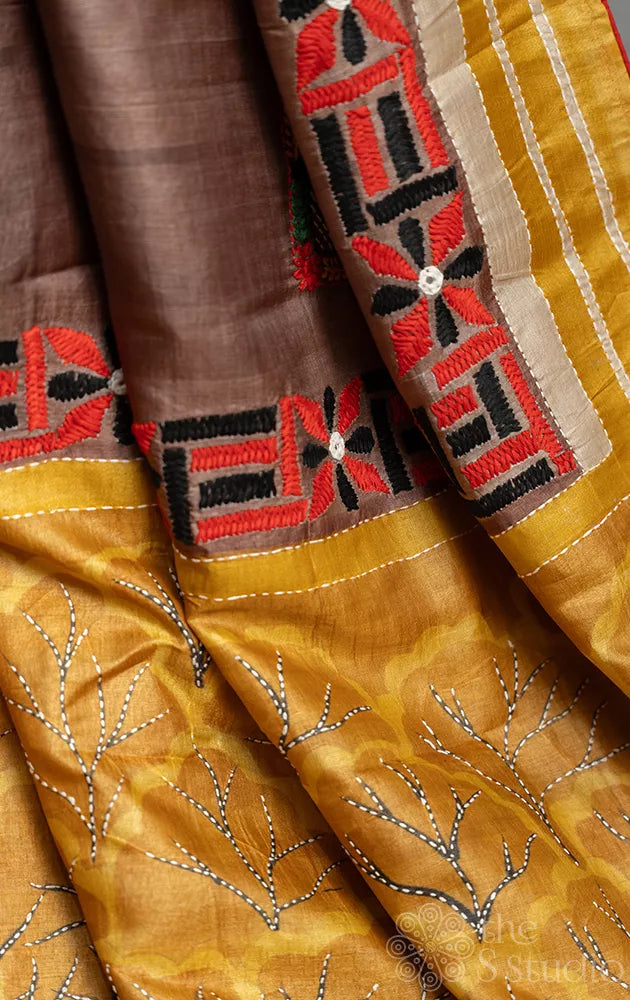 Brown and mustard hand embroidered tussar silk saree with hand batik prints