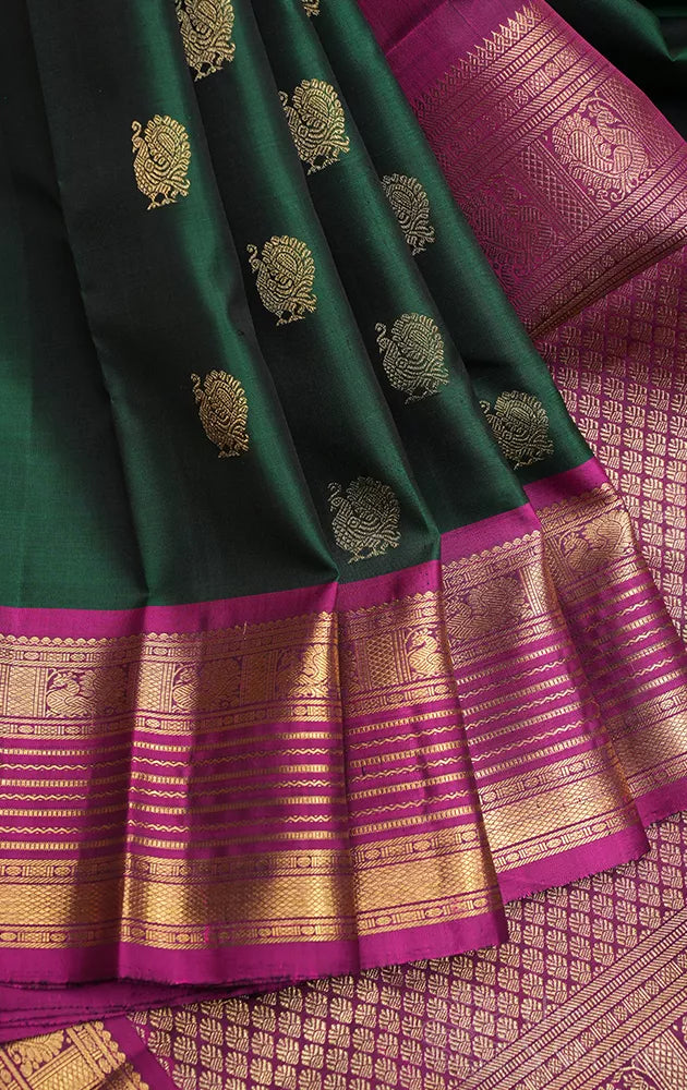 Bottle green kanjivaram silk saree with magenta border