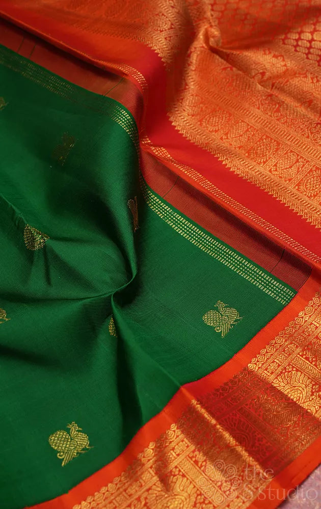 Leaf green kanchi pattu saree with korvai orange border