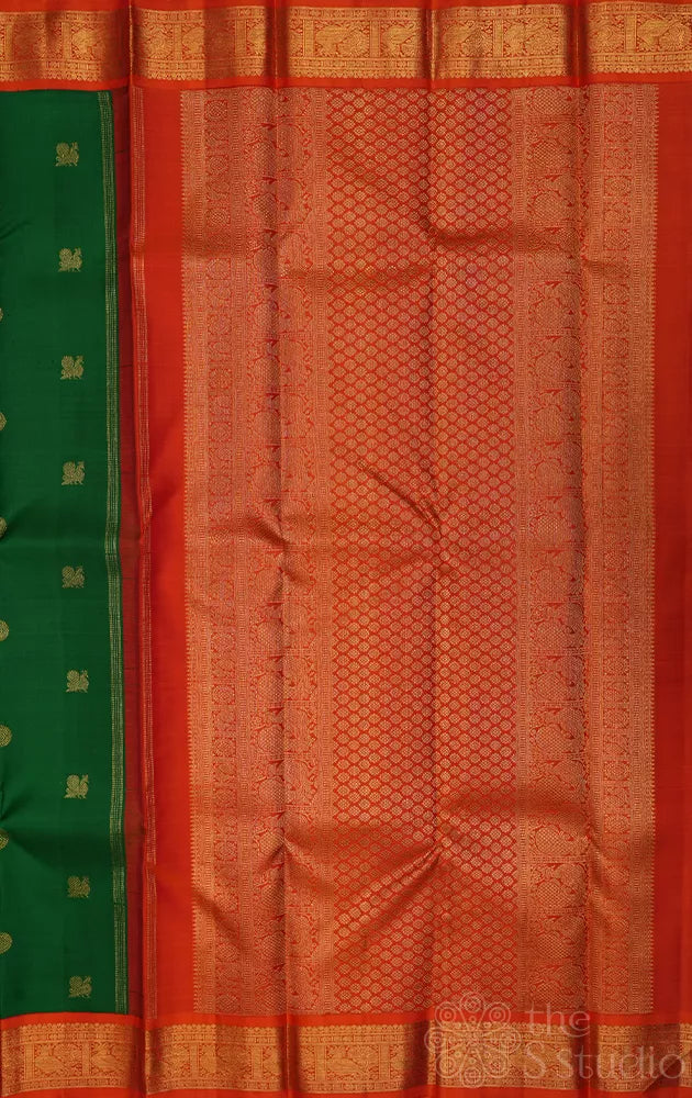 Leaf green kanchi pattu saree with korvai orange border