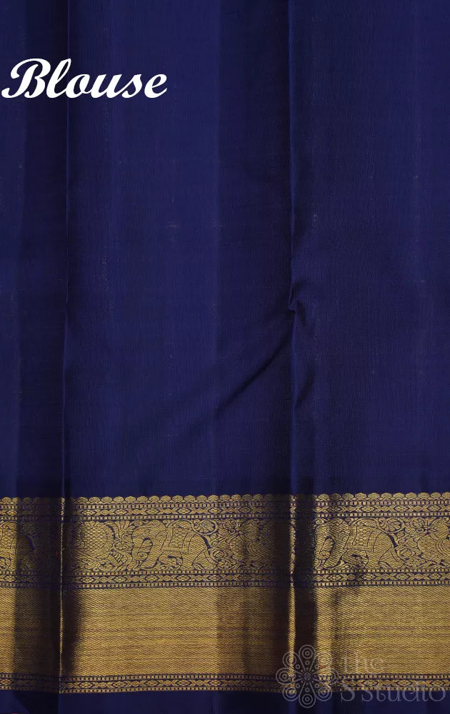 Rust orange kanchi pattu saree with navy blue korvai border