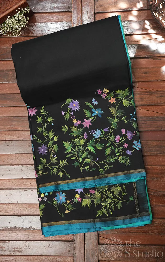 Black kanchipuram silk saree with floral hand painting and a sea green pallu