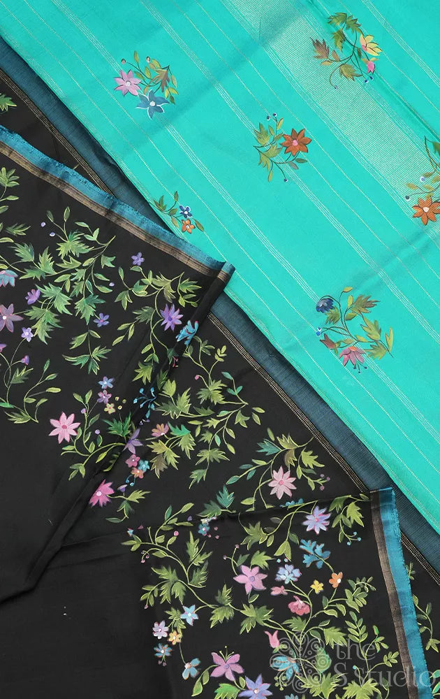 Black kanchipuram silk saree with floral hand painting and a sea green pallu