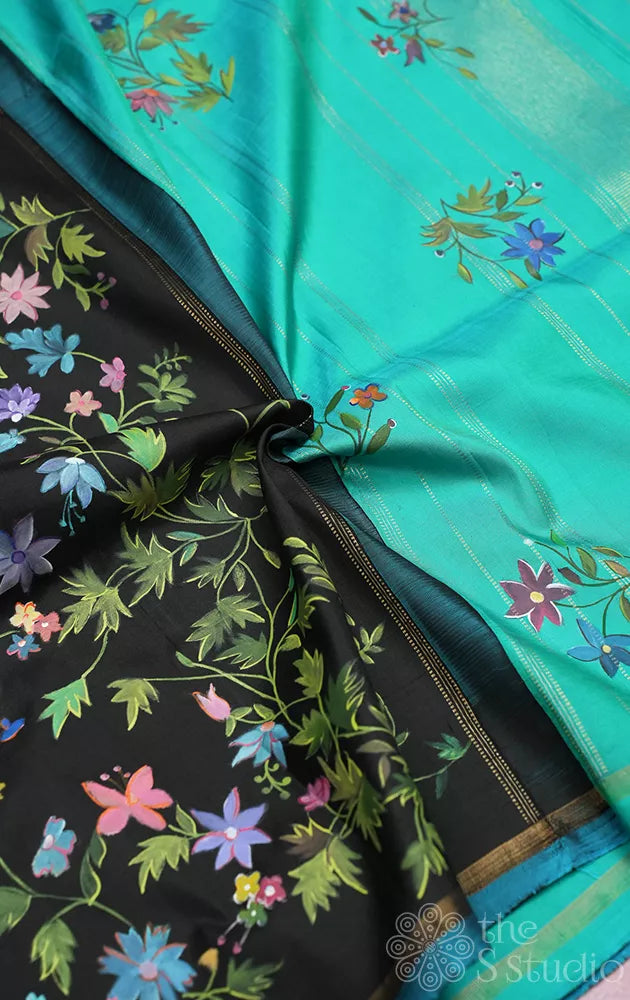 Black kanchipuram silk saree with floral hand painting and a sea green pallu