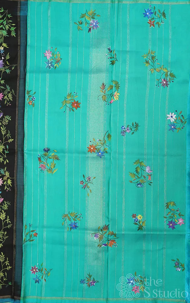 Black kanchipuram silk saree with floral hand painting and a sea green pallu