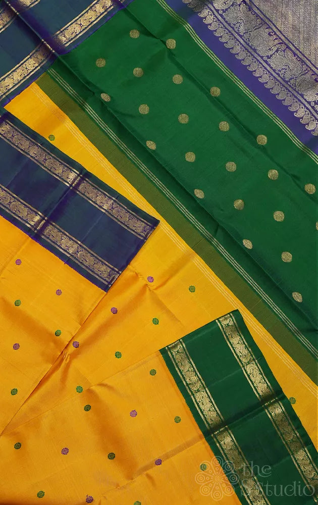 Mustard korvai kanjivaram silk saree with peacock blue and green border