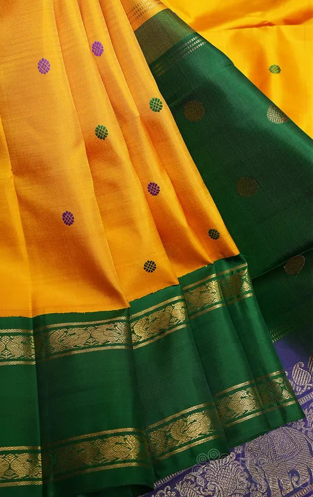 Mustard korvai kanjivaram silk saree with peacock blue and green border