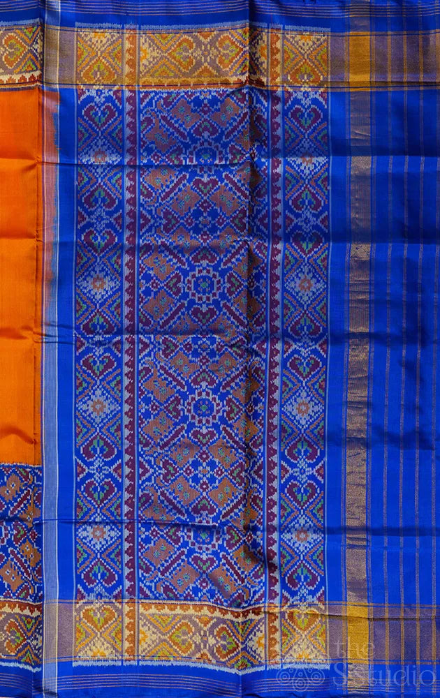 Orange patola silk saree with blue border in ikat design