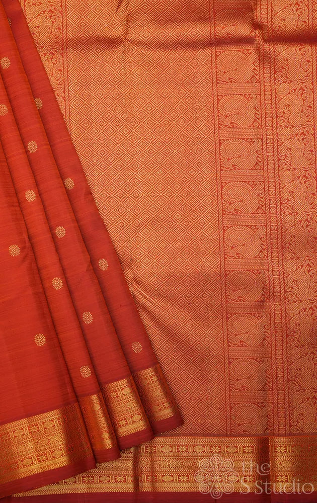 Rust kanchi silk saree with kamalam buttas and zari woven border