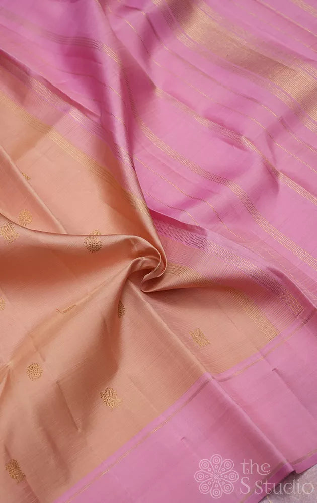 Light peach kanchi silk saree with zari bhuttas and pink border