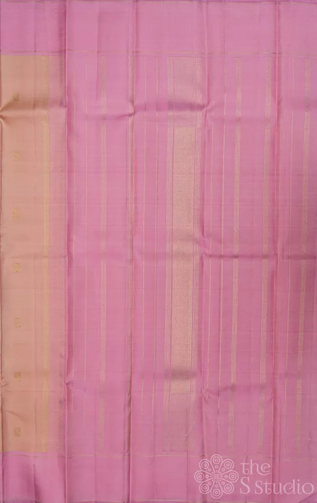 Light peach kanchi silk saree with zari bhuttas and pink border