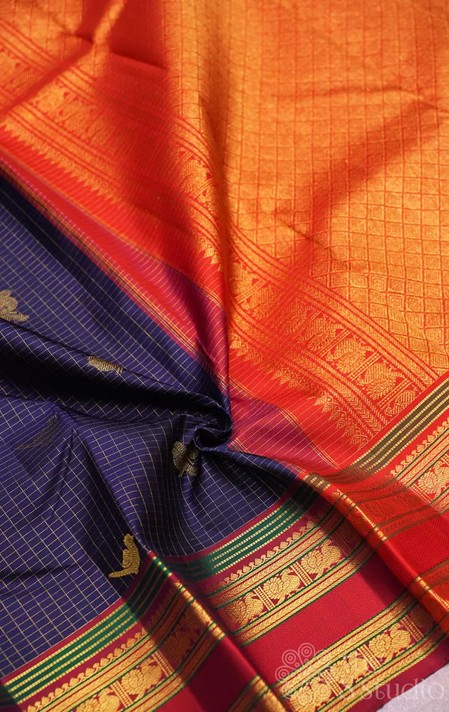Navy blue checked kanjivaram silk saree with red rettaipet border