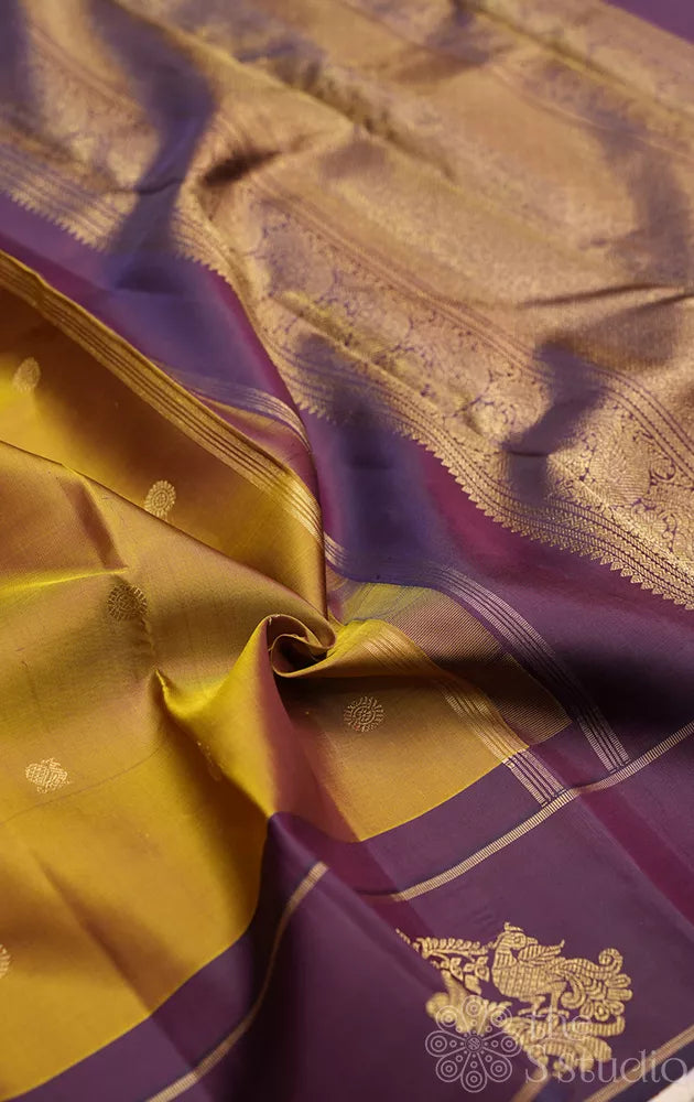 Golden green kanchi pattu saree with deep purple border