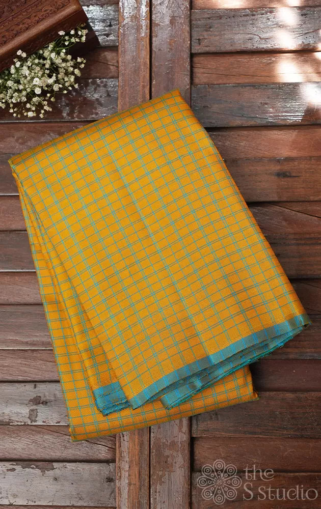 Yellow borderless kanchi pattu saree with blue checks