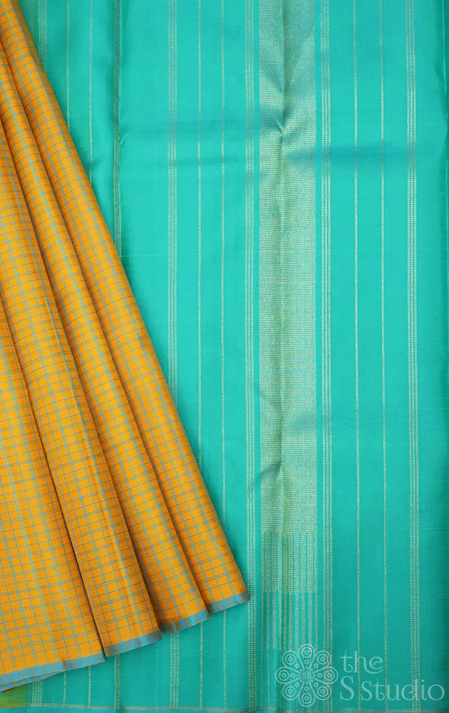 Yellow borderless kanchi pattu saree with blue checks