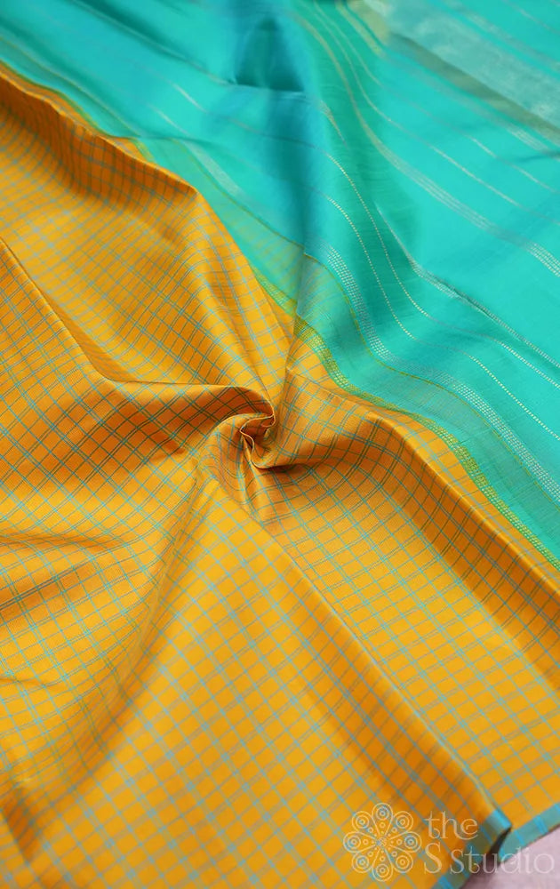 Yellow borderless kanchi pattu saree with blue checks