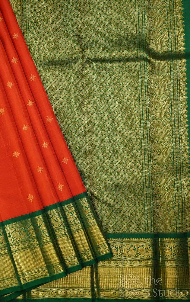 Rust orange kanchi pattu saree with korvai green zari border