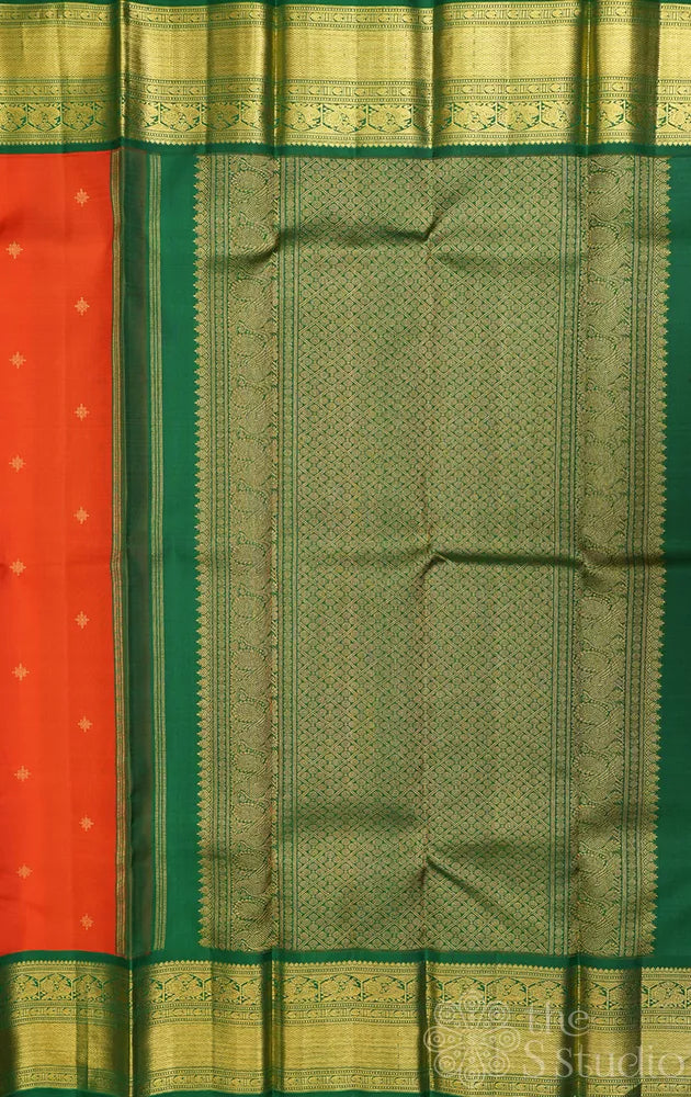 Rust orange kanchi pattu saree with korvai green zari border