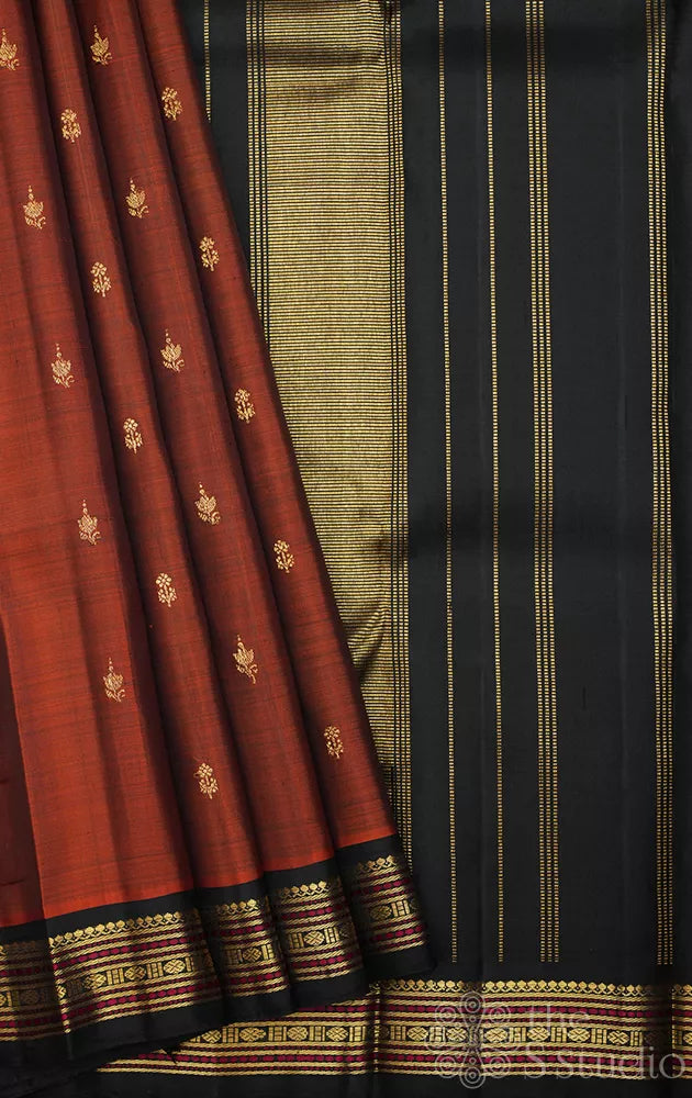 Rust kanjeevaram silk saree with small black meenakari border