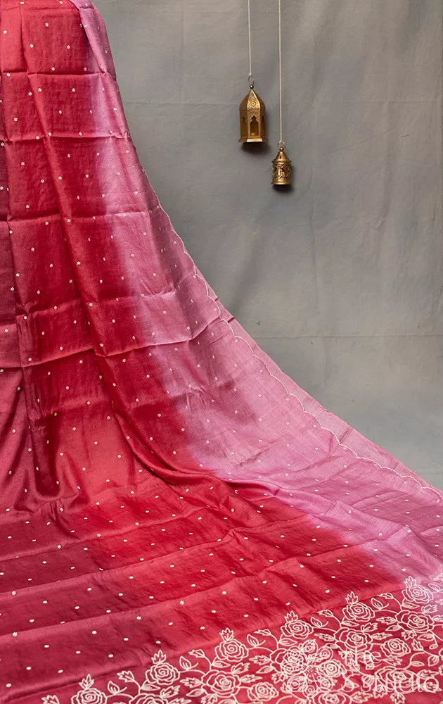 Maroon shaded tussar silk saree with white floral embroidery and scallop border