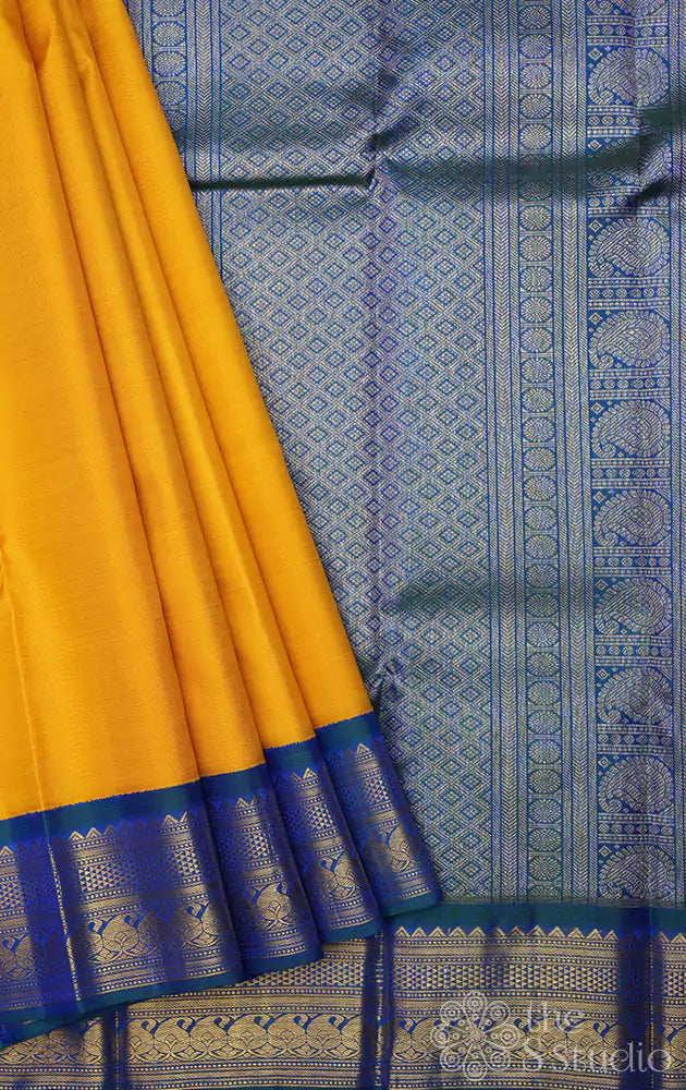 Mustard yellow kanjivaram saree with korvai border