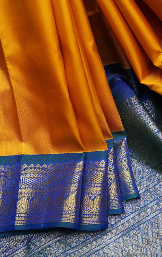 Mustard yellow kanjivaram saree with korvai border