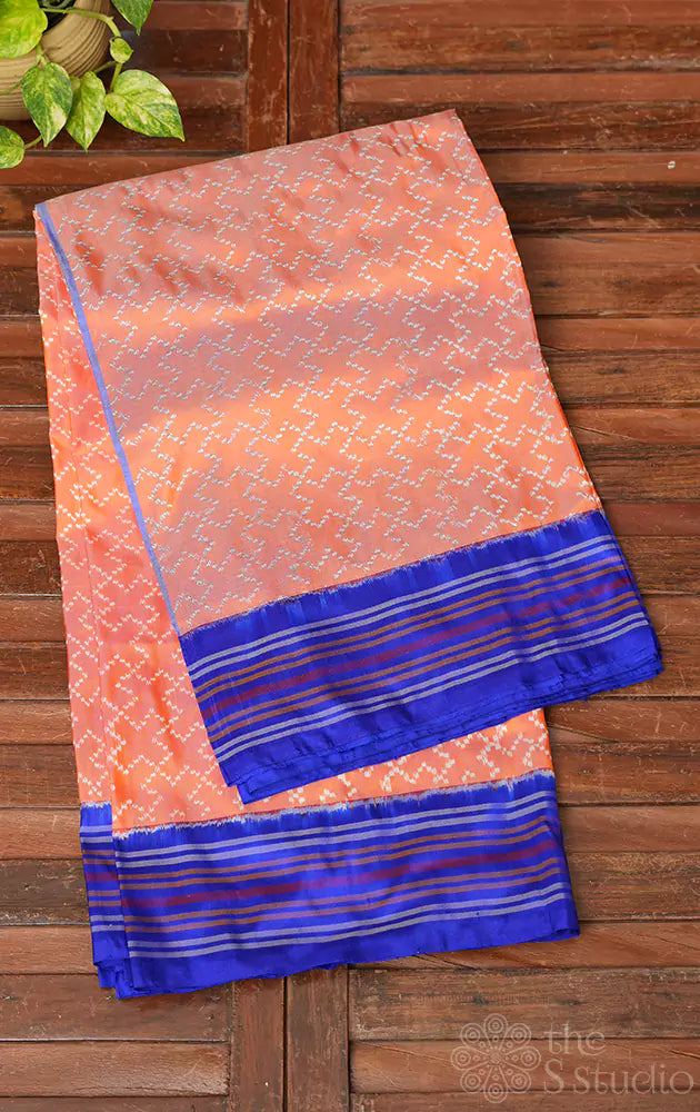 Peach twill ikkat silk saree with blue border