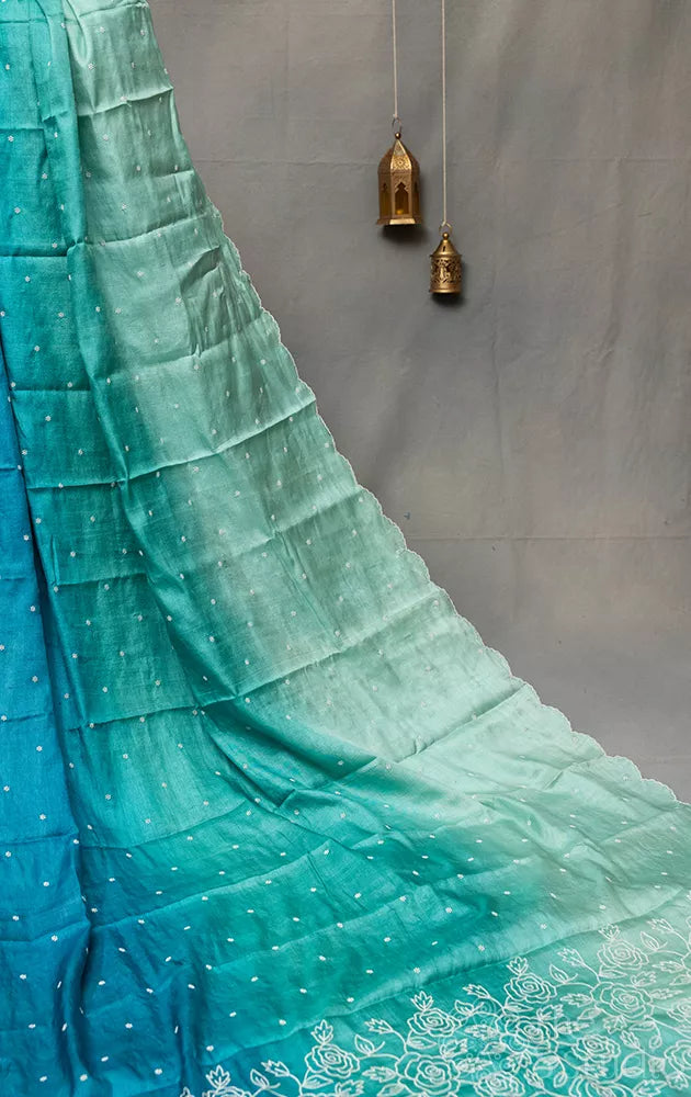 Shades of blue tussar silk saree with white embroidery and scallop border
