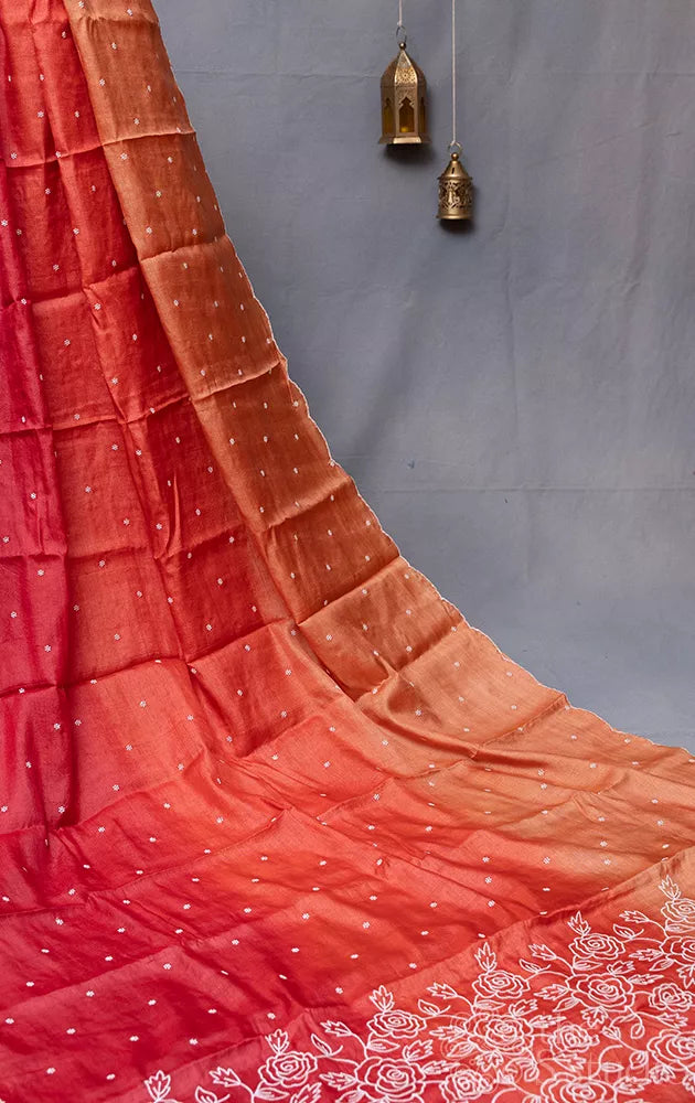 Shades of rust orange tussar silk saree with white embroidery and scallop border