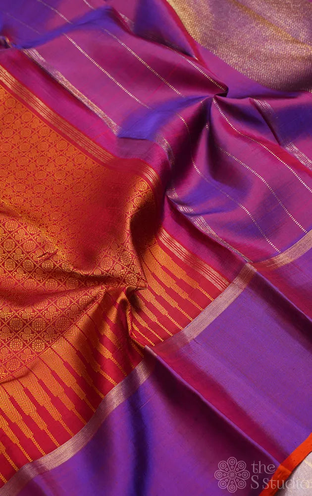 Reddish orange kanchi silk saree with a purple border