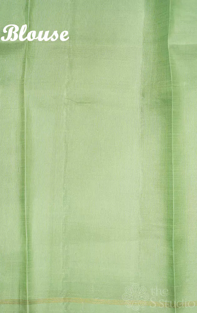 Off white kanchipuram silk saree with pastel prints and elachi green pallu