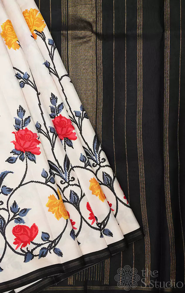 White kanchi pattu saree with floral prints and black pallu