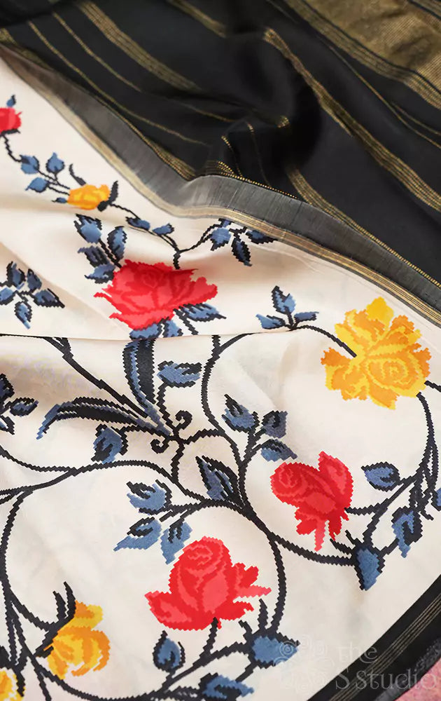 White kanchi pattu saree with floral prints and black pallu