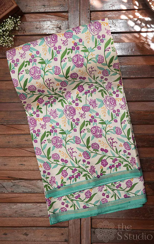 Off white kanchippuram silk saree with small floral prints and sea green pallu