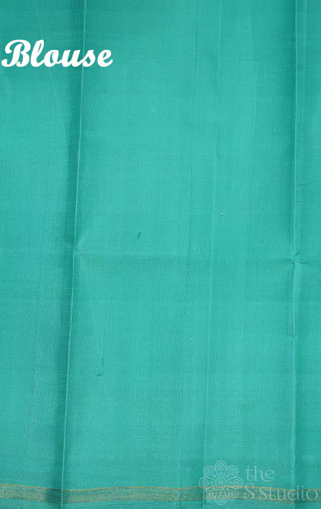 Off white kanchipuram silk saree with small floral prints and sea green pallu