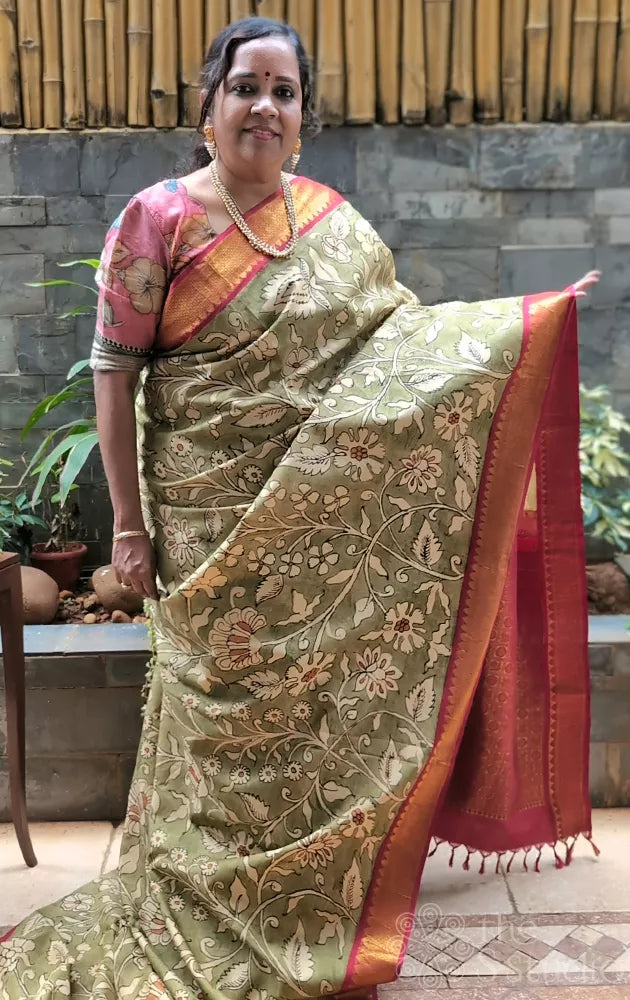 Olive green coloured kanchi hand painted kalamkari saree with korvai red border