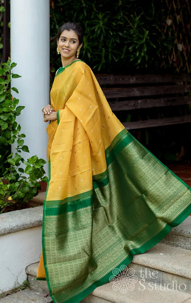 Yellow kora kanchipuram silk saree with green pallu