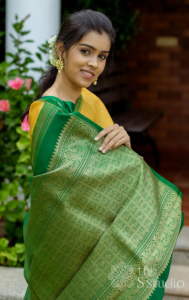 Yellow kora kanchipuram silk saree with green pallu
