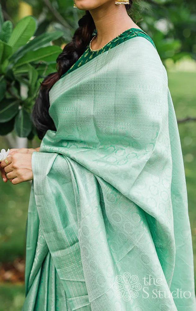 Pastel green kanchi silk saree with silver zari