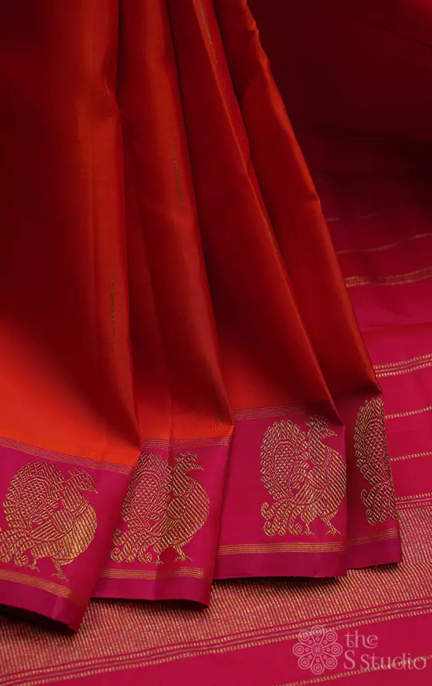 Orange kanchi silk saree with peacock motifs
