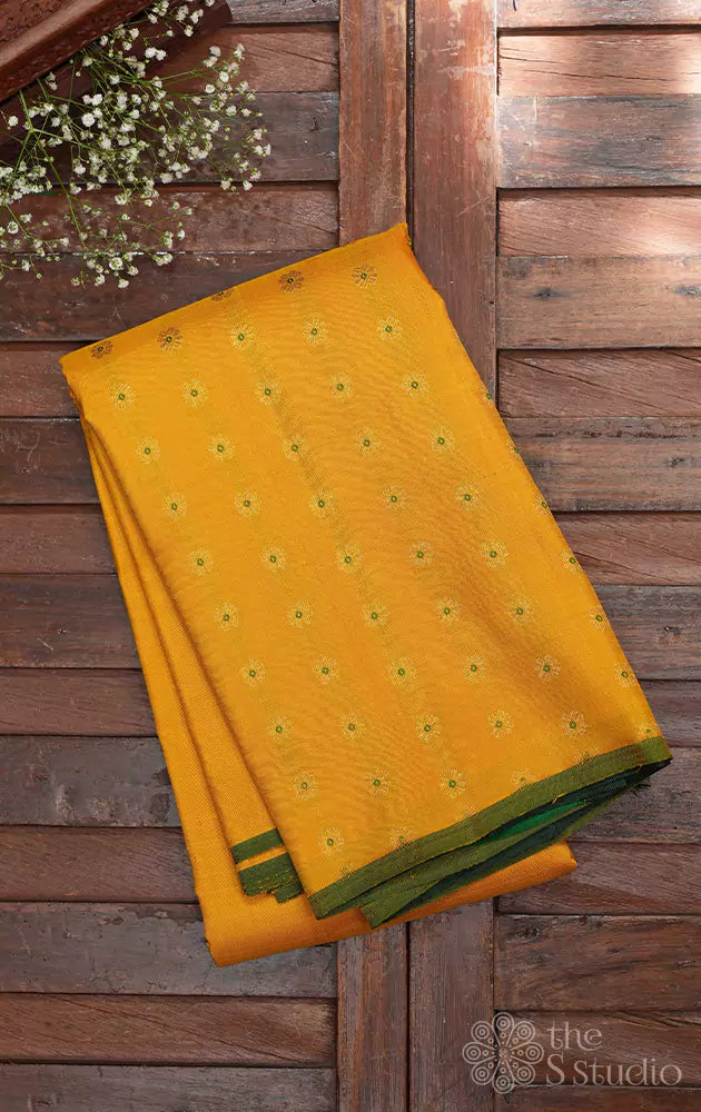 Yellow kanchipuram silk saree woven with meena buttas and a contrast green pallu