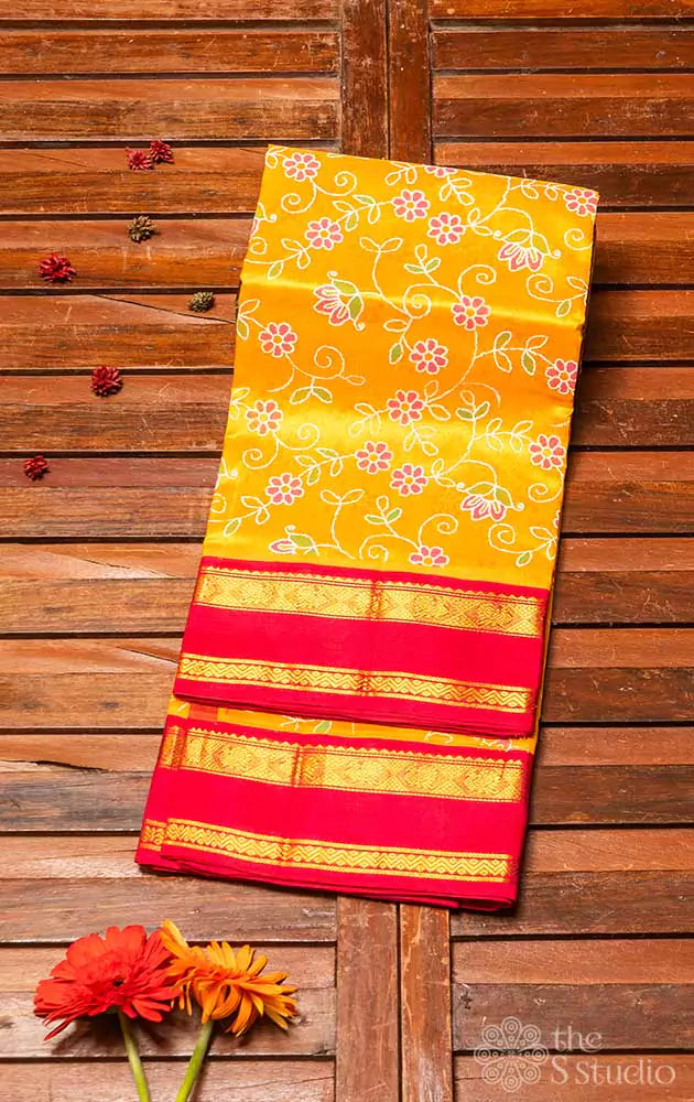 Yellow silk cotton saree with block print and red border